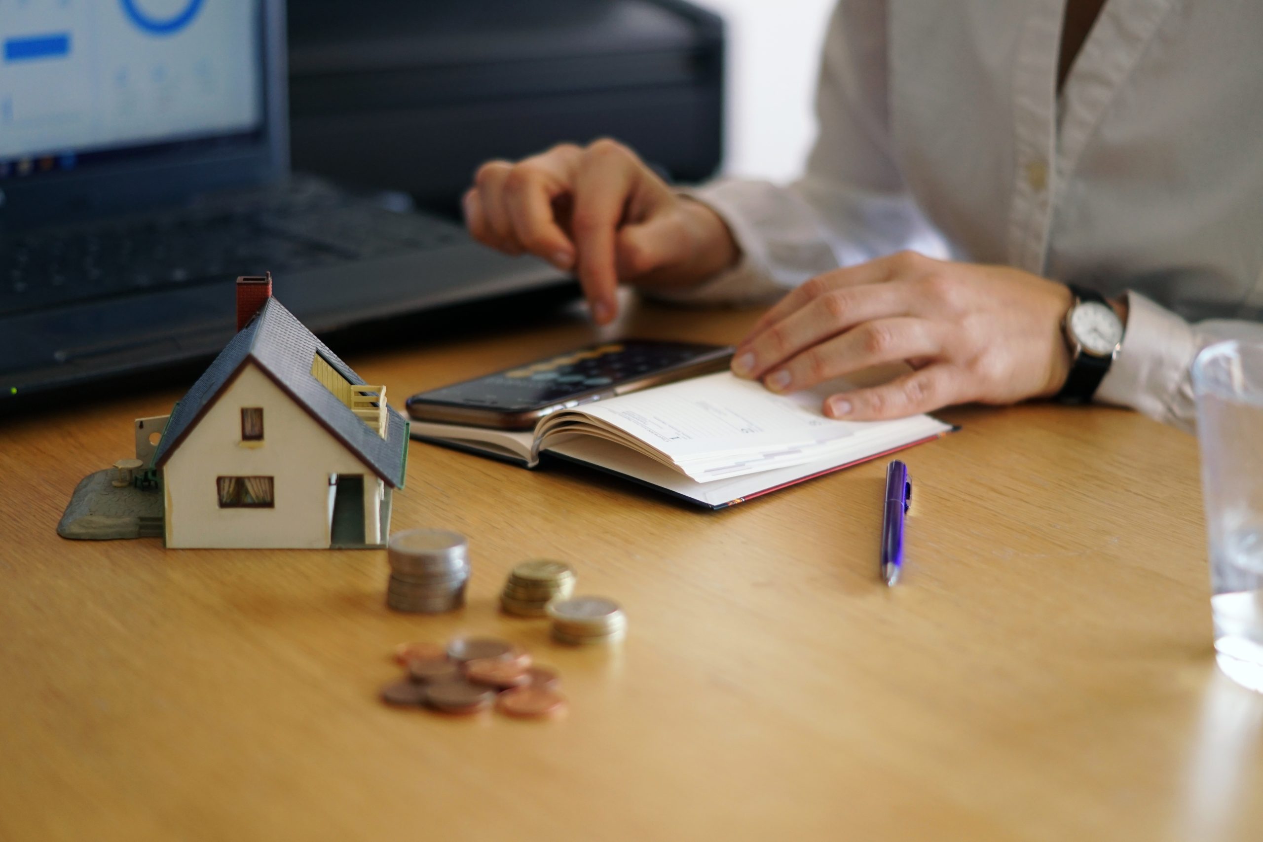 A closeup shot of a person thinking of buying or selling a house